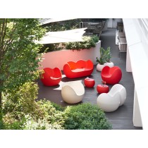 Table basse Blos utilisée en extérieur avec des fauteuils Blos design et un canapé Blossy rouge.